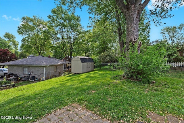 view of yard with a storage unit, a fenced backyard, and an outdoor structure