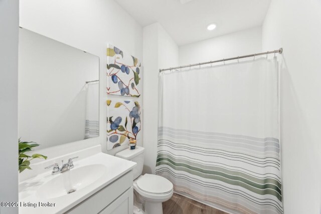 11036 Pheasant Hill Cir, Louisville, KY 40229 - full bath with vanity, a shower with shower curtain, wood finished floors, and toilet