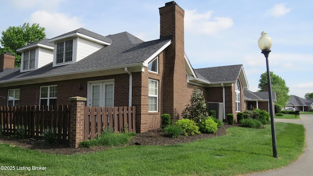10002 Brownsboro Gardens Cir, Louisville, KY 40241 - view of home's exterior with brick siding, a lawn, fence, and a chimney