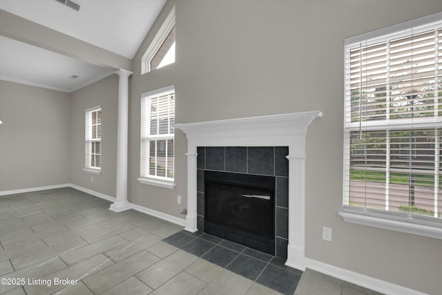 10002 Brownsboro Gardens Cir, Louisville, KY 40241 - unfurnished living room featuring baseboards, decorative columns, a tile fireplace, dark tile patterned flooring, and ornamental molding