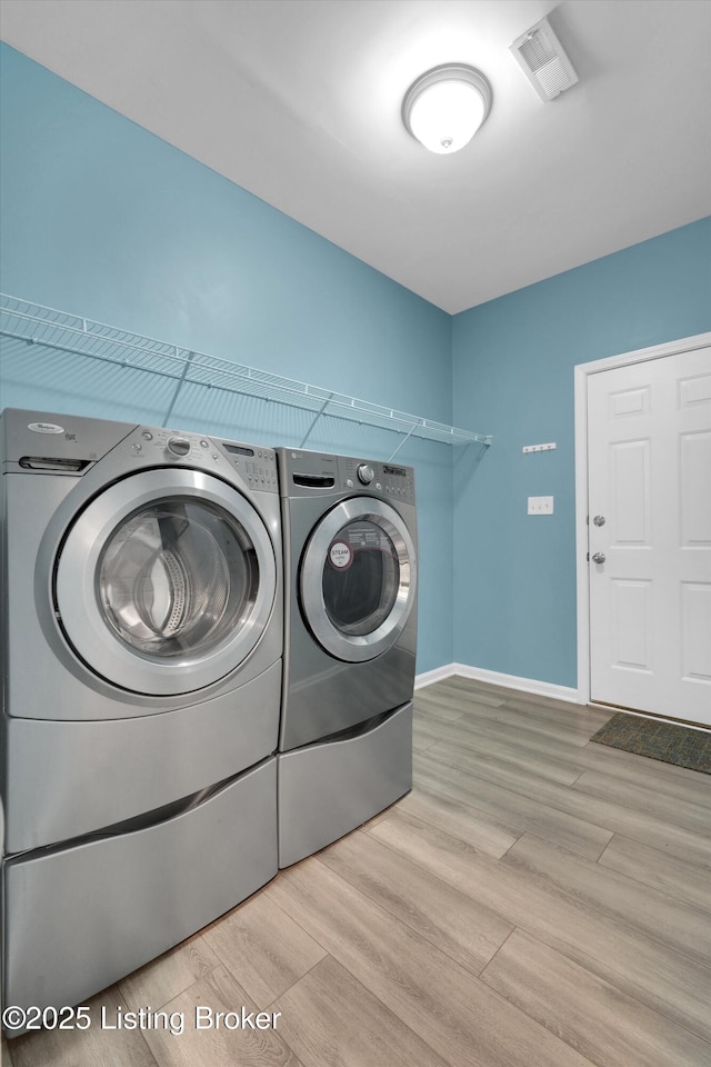 10002 Brownsboro Gardens Cir, Louisville, KY 40241 - clothes washing area featuring laundry area, washer and clothes dryer, wood finished floors, and visible vents