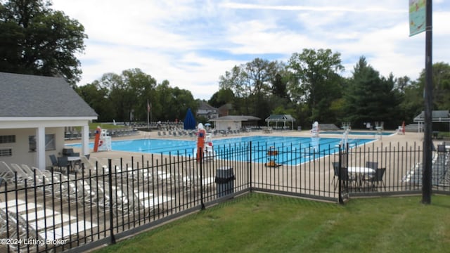 community pool featuring a patio and fence