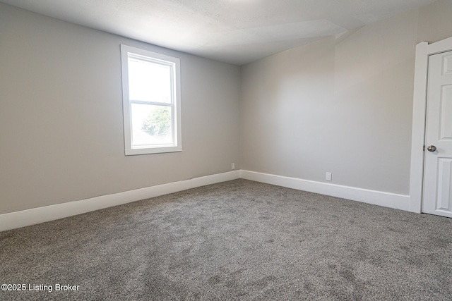 carpeted spare room with baseboards