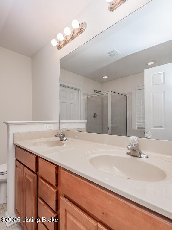220 Rockcrest Way, Louisville, KY 40245 - full bathroom featuring a shower stall, toilet, double vanity, tile patterned floors, and recessed lighting