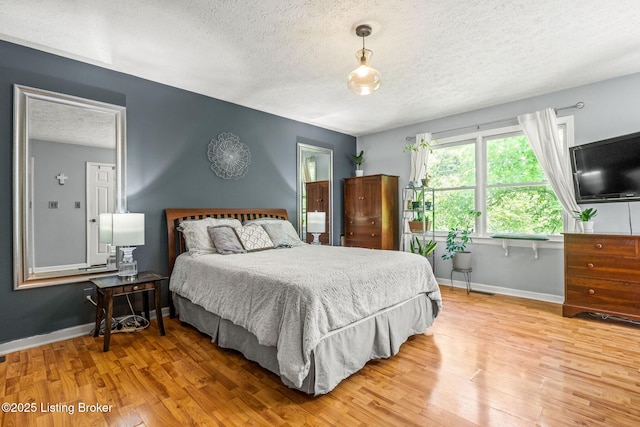 3003 Coffee Tree Ct, Crestwood, KY 40014 - bedroom with a textured ceiling, light wood finished floors, and baseboards