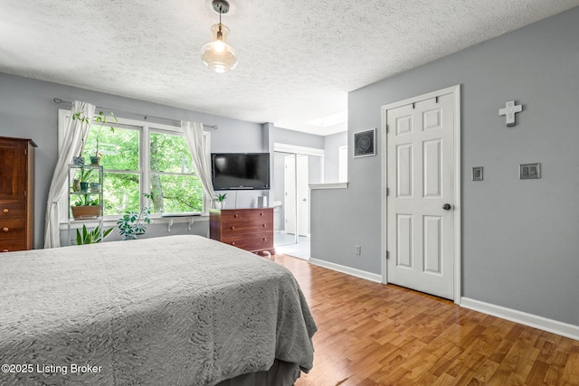 3003 Coffee Tree Ct, Crestwood, KY 40014 - bedroom featuring wood finished floors, baseboards, and a textured ceiling