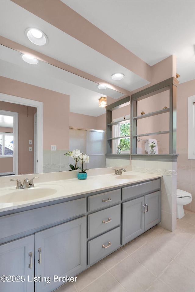 418 Glensford Dr, Louisville, KY 40245 - bathroom with tile patterned flooring, double vanity, tile walls, toilet, and recessed lighting