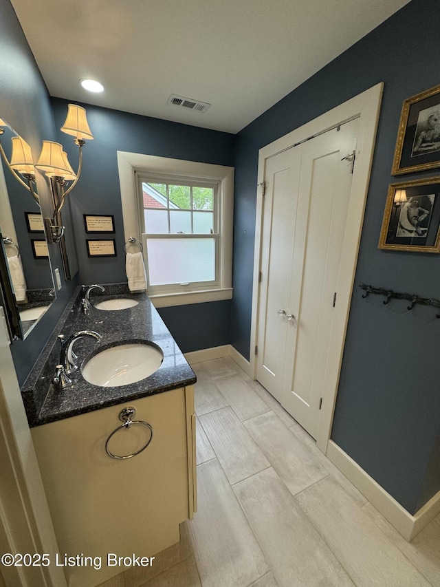 2302 Woodford Pl, Louisville, KY 40205 - full bath featuring double vanity, baseboards, visible vents, and a sink