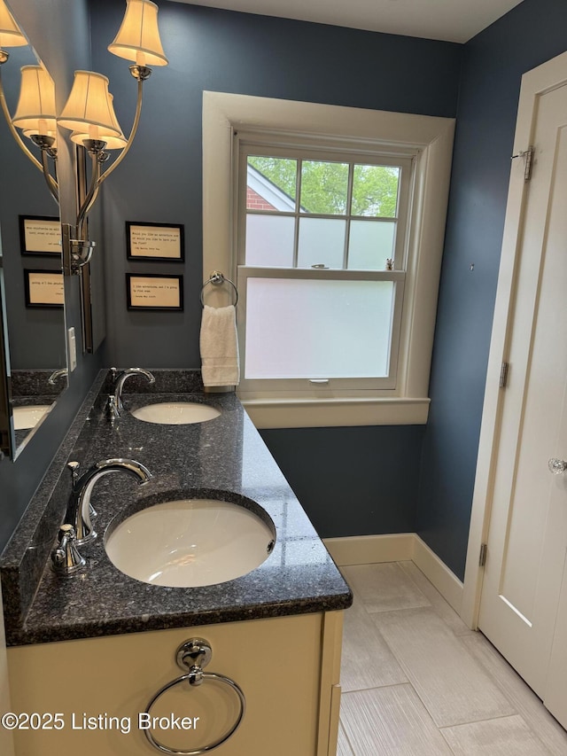 2302 Woodford Pl, Louisville, KY 40205 - full bathroom featuring double vanity, baseboards, and a sink