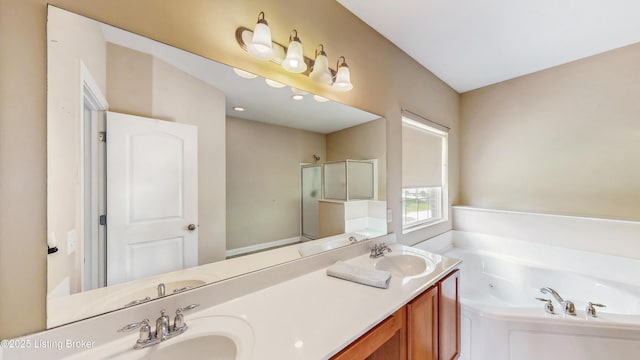 bathroom with a jetted tub, a sink, double vanity, and a shower stall