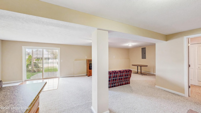 basement featuring carpet floors, baseboards, and electric panel