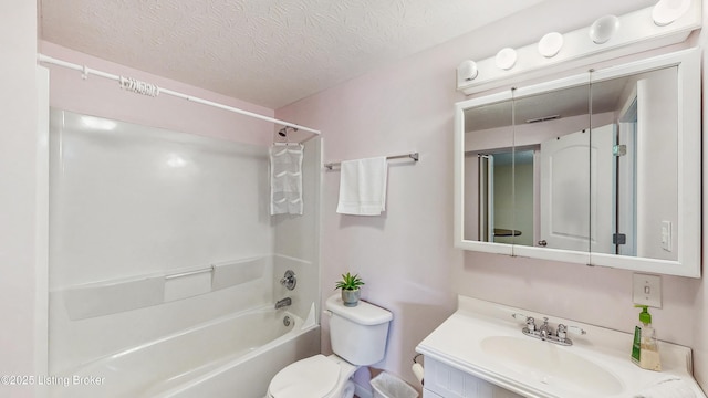 bathroom featuring vanity, toilet, a textured ceiling, and shower / washtub combination