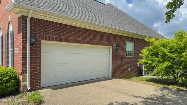 garage featuring concrete driveway
