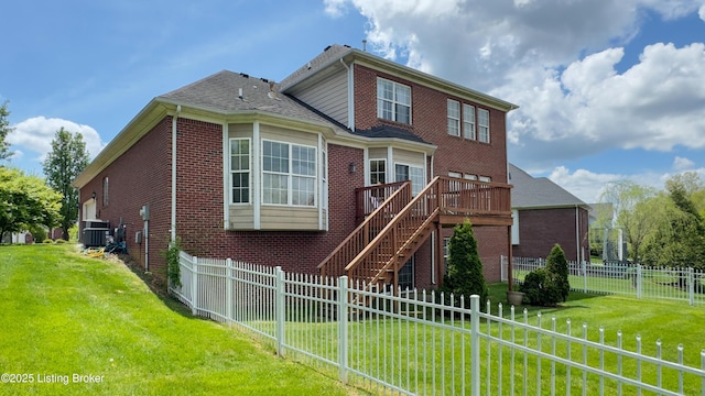 view of front facade featuring a fenced backyard, central AC, a front lawn, and brick siding