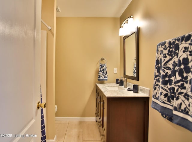 bathroom featuring vanity, visible vents, toilet, baseboards, and tile patterned floors
