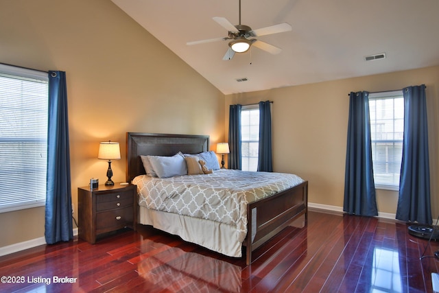 bedroom with baseboards, visible vents, multiple windows, and wood finished floors