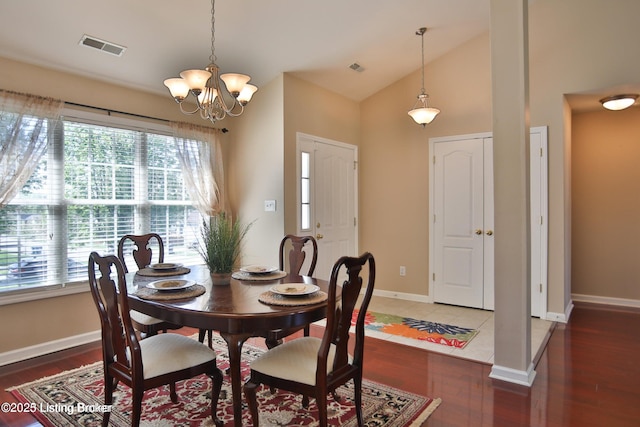 dining space with baseboards, visible vents, wood finished floors, and a chandelier