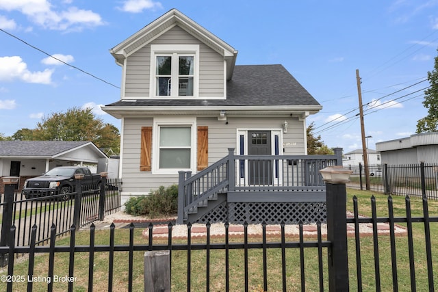 view of front of property featuring a gate, a shingled roof, fence private yard, and a front yard