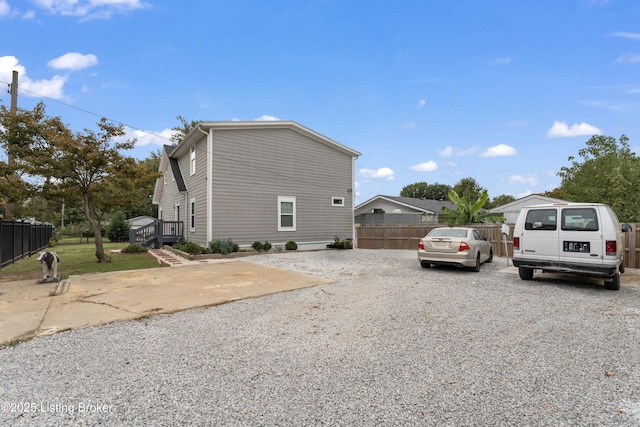 view of home's exterior with fence