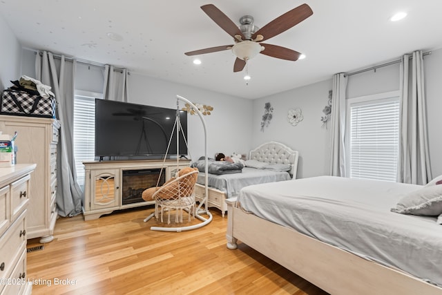 bedroom with recessed lighting, a ceiling fan, and light wood finished floors