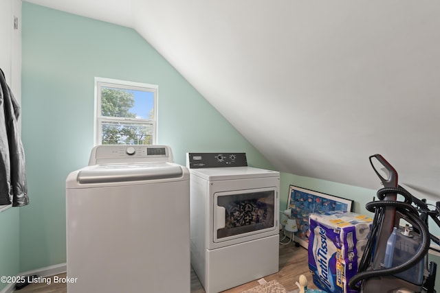washroom featuring independent washer and dryer, laundry area, and wood finished floors