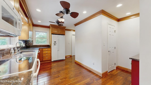 kitchen with white appliances, crown molding, a sink, and ceiling fan