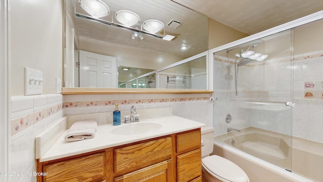 full bath with vanity, enclosed tub / shower combo, toilet, and tasteful backsplash