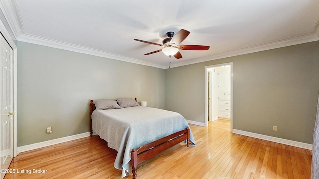 bedroom featuring crown molding, baseboards, ceiling fan, and light wood-style flooring