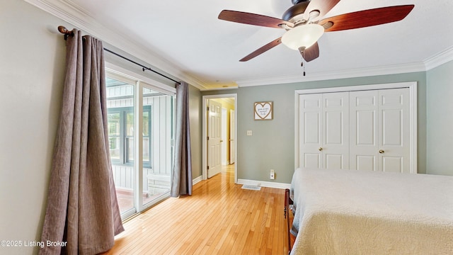 bedroom featuring baseboards, ornamental molding, a closet, light wood finished floors, and access to outside