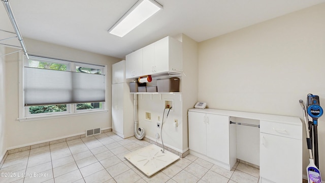 washroom featuring visible vents, hookup for a washing machine, cabinet space, light tile patterned floors, and hookup for an electric dryer