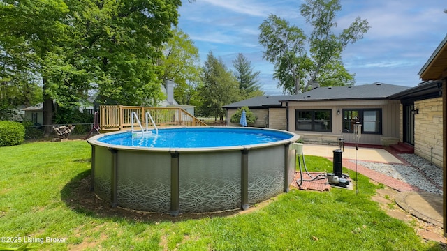 pool with fence and a yard