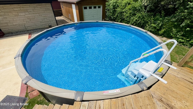 view of swimming pool with an outdoor structure