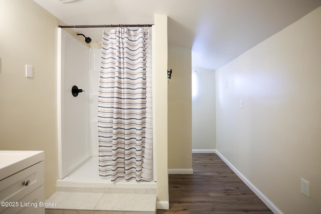 9500 Galene Dr, Louisville, KY 40299 - bathroom featuring baseboards, vanity, wood finished floors, and a shower stall