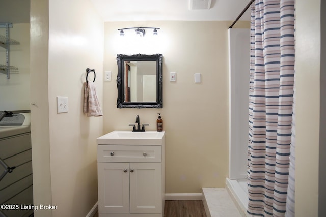 9500 Galene Dr, Louisville, KY 40299 - bathroom featuring vanity, baseboards, wood finished floors, visible vents, and a stall shower
