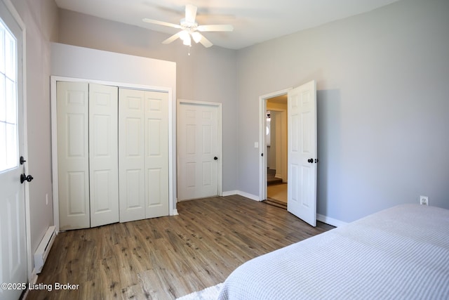 9500 Galene Dr, Louisville, KY 40299 - unfurnished bedroom with wood finished floors, baseboards, baseboard heating, and a closet