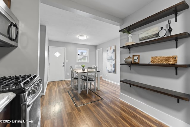 dining space with baseboards and dark wood-style flooring
