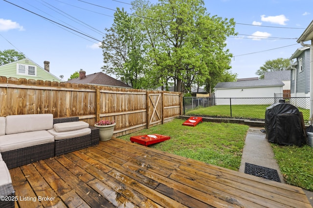 wooden deck with a lawn, an outdoor hangout area, and a fenced backyard