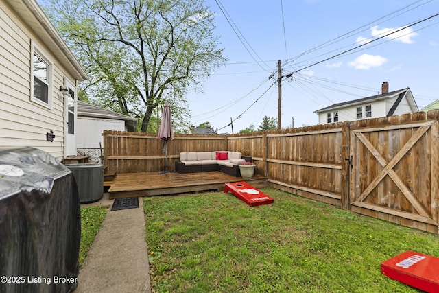 view of yard featuring a deck, central AC, an outdoor living space, and a fenced backyard