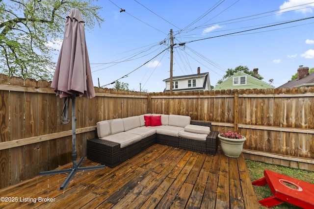 deck featuring an outdoor living space and a fenced backyard