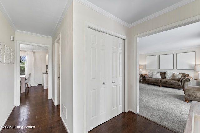 hall with crown molding, dark wood finished floors, baseboards, and visible vents