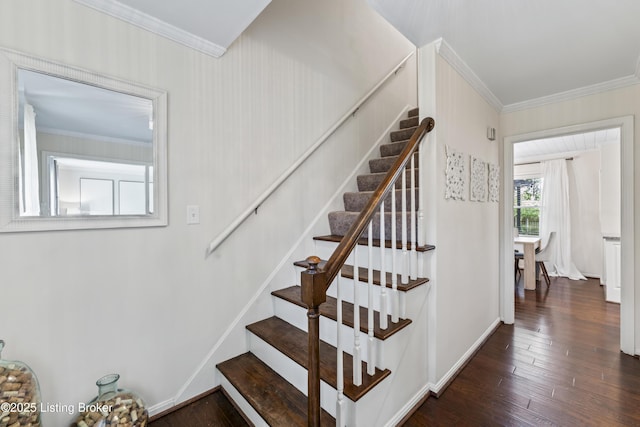 stairway featuring ornamental molding and wood finished floors