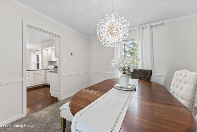 dining room featuring baseboards, a chandelier, ornamental molding, and dark carpet