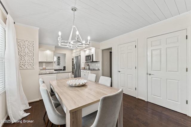 dining area featuring crown molding, a chandelier, and dark wood finished floors