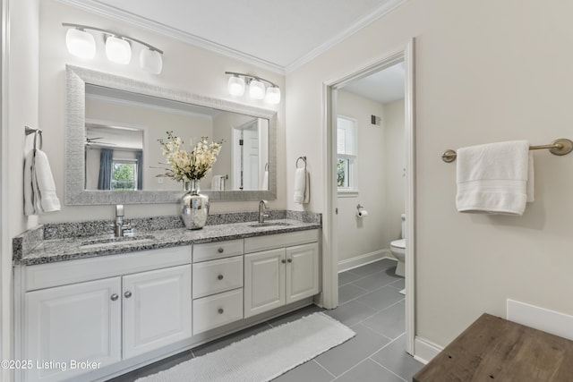 full bathroom featuring double vanity, a sink, tile patterned flooring, and toilet
