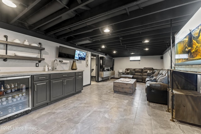 interior space with beverage cooler, a sink, and wet bar