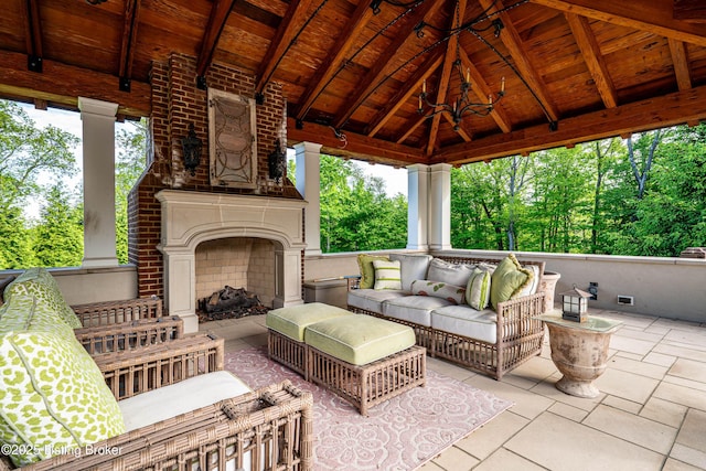 view of patio featuring a gazebo and an outdoor living space with a fireplace