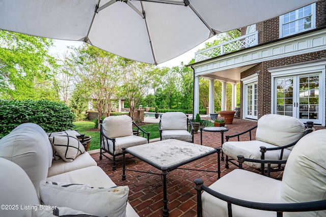 view of patio / terrace featuring an outdoor living space, a balcony, and french doors