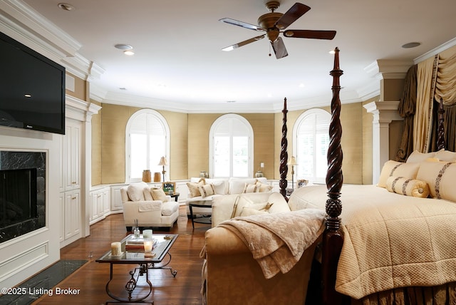 bedroom with a high end fireplace, recessed lighting, ornamental molding, and dark wood finished floors