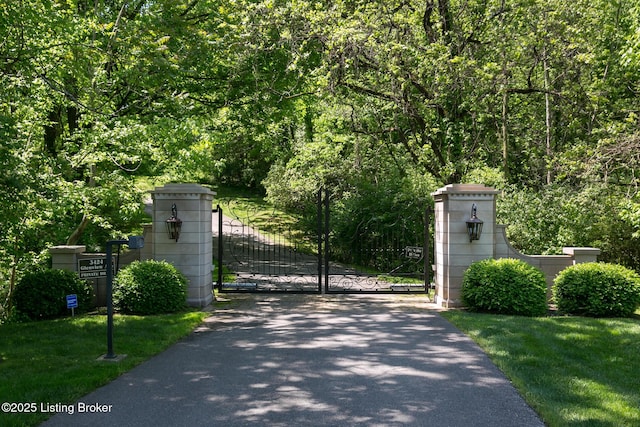 view of gate with a forest view