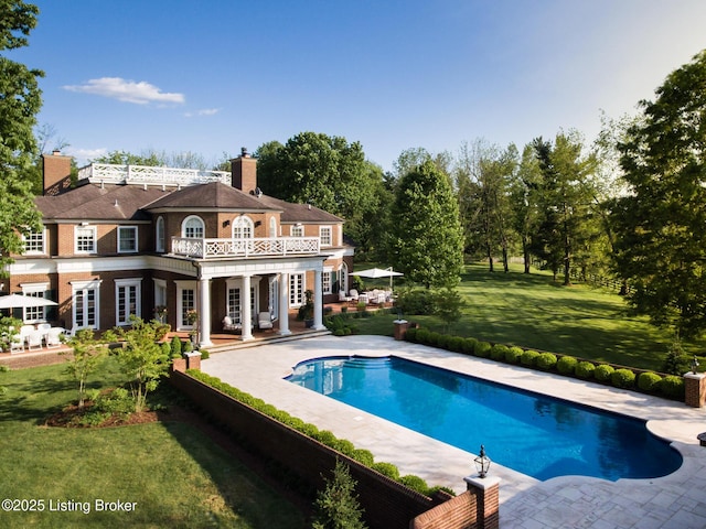 view of swimming pool featuring a fenced in pool, french doors, a patio area, and a yard